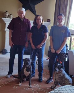 Family Posing With Their Dogs